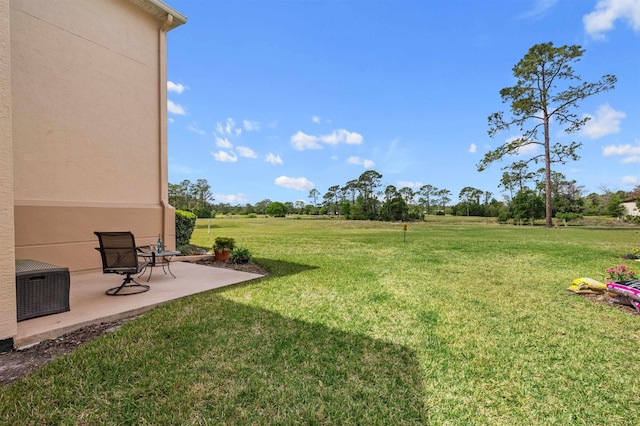 view of yard with cooling unit and a patio