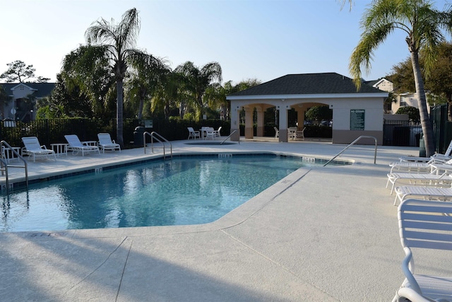 pool with fence, a gazebo, and a patio