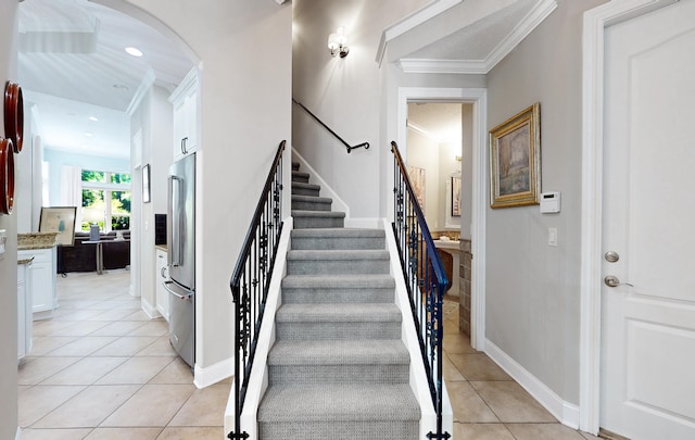 113 Holly Berry Ln, Saint Johns, FL 32259 - staircase featuring tile patterned floors, crown molding, baseboards, arched walkways, and recessed lighting