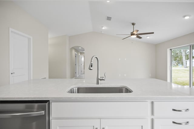 kitchen with white cabinetry, sink, lofted ceiling, and dishwasher