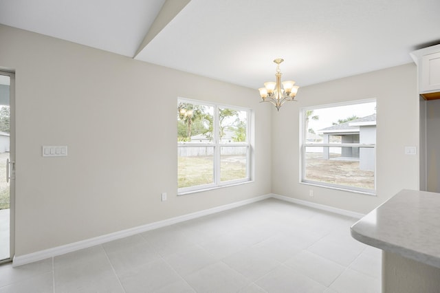 unfurnished dining area with a notable chandelier