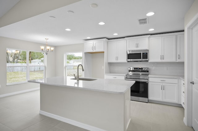 kitchen with sink, a center island with sink, white cabinets, and appliances with stainless steel finishes