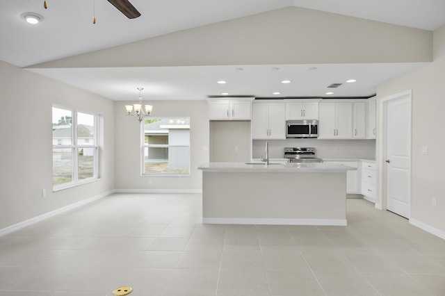 kitchen featuring sink, appliances with stainless steel finishes, pendant lighting, a kitchen island with sink, and white cabinets