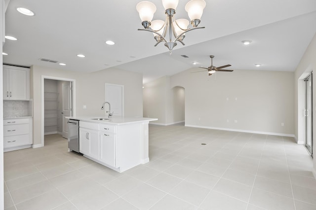 kitchen featuring white cabinetry, stainless steel dishwasher, sink, and an island with sink