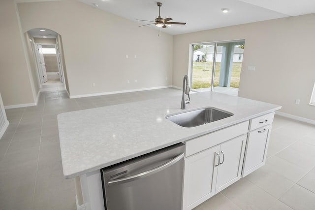 kitchen with sink, white cabinetry, light stone counters, dishwasher, and an island with sink