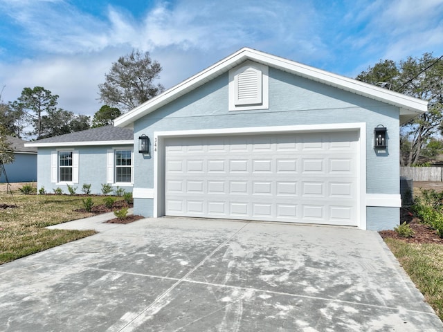 single story home featuring a garage and a front yard