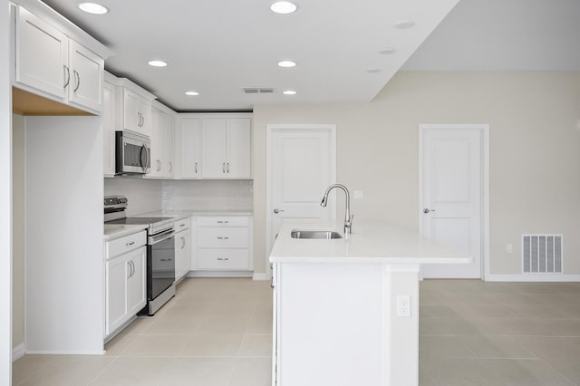 kitchen with sink, a center island with sink, white cabinets, and appliances with stainless steel finishes