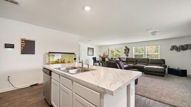 4004 Chihuahua Ct, Jacksonville, FL 32218 - kitchen featuring dishwasher, open floor plan, light countertops, dark wood finished floors, and white cabinetry