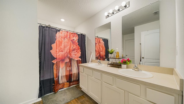 4004 Chihuahua Ct, Jacksonville, FL 32218 - full bath with double vanity, wood finished floors, a textured ceiling, and a shower with shower curtain