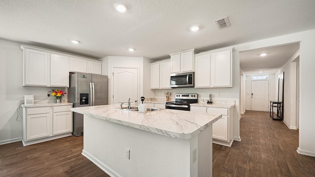 4004 Chihuahua Ct, Jacksonville, FL 32218 - kitchen with appliances with stainless steel finishes, dark wood-style floors, white cabinetry, light countertops, and a center island with sink