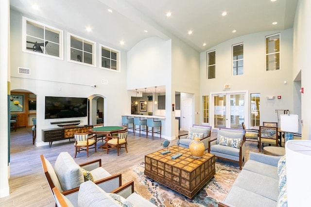 living room with light hardwood / wood-style floors and lofted ceiling