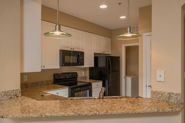 8539 Gate Pkwy Unit 431, Jacksonville, FL 32216 - kitchen with white cabinets, a sink, black appliances, and light stone counters