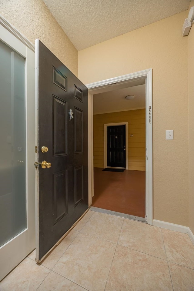 8539 Gate Pkwy Unit 431, Jacksonville, FL 32216 - interior space featuring a textured ceiling, light tile patterned floors, a textured wall, and baseboards