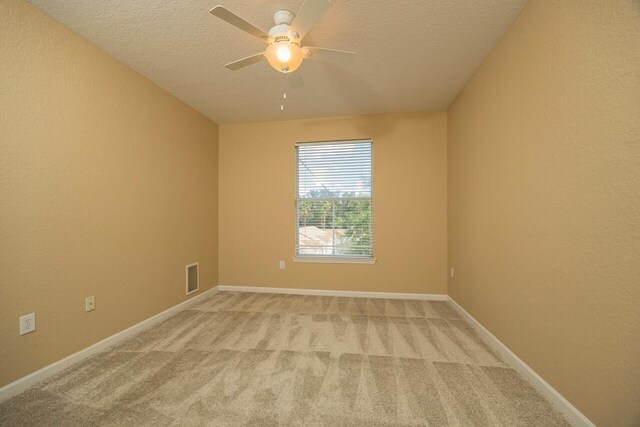 8539 Gate Pkwy Unit 431, Jacksonville, FL 32216 - empty room with visible vents, baseboards, ceiling fan, a textured ceiling, and light colored carpet