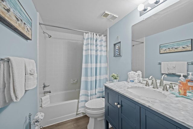 full bathroom featuring wood-type flooring, vanity, shower / tub combo with curtain, and toilet