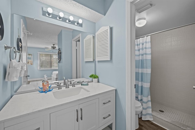 bathroom with a shower with curtain, vanity, a textured ceiling, and toilet