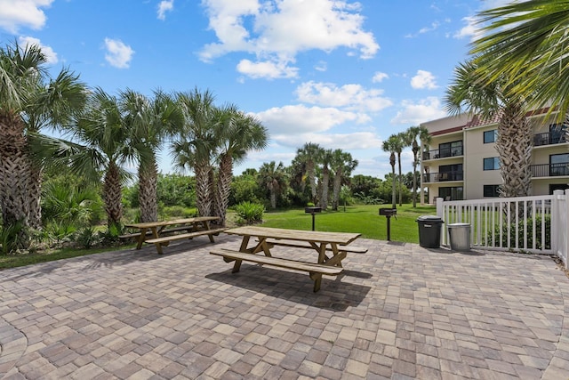 view of community featuring a yard and a patio