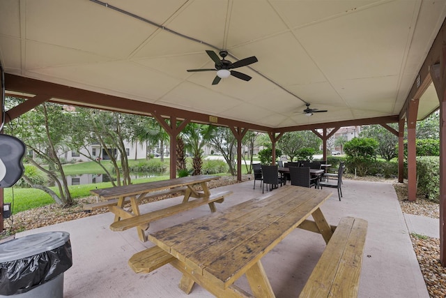 view of patio with a water view and ceiling fan