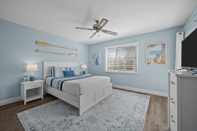 bedroom featuring a textured ceiling, dark hardwood / wood-style floors, and ceiling fan