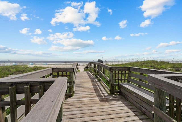 view of community featuring a beach view and a water view