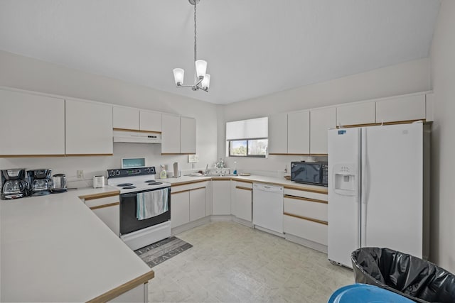 kitchen featuring hanging light fixtures, a notable chandelier, white cabinets, and white appliances