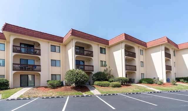 view of building exterior with uncovered parking