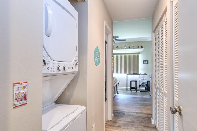 8550 S A1A Unit 323, Saint Augustine, FL 32080 - laundry area with stacked washing machine and dryer, wood finished floors, and a ceiling fan