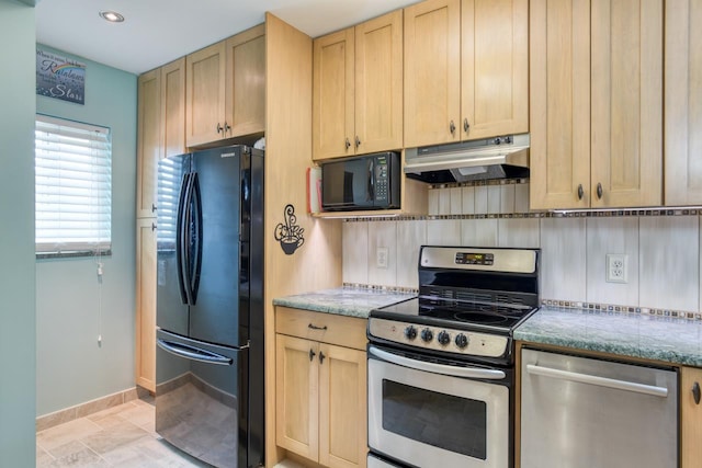 8550 S A1A Unit 323, Saint Augustine, FL 32080 - kitchen with black appliances, under cabinet range hood, light brown cabinets, baseboards, and light stone counters