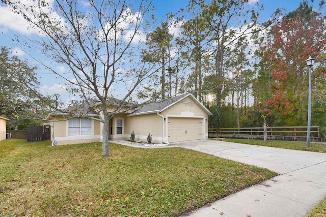 single story home featuring a garage and a front lawn