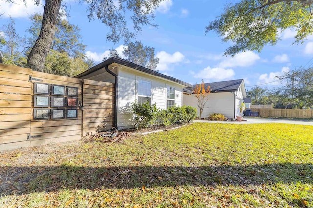 view of side of home featuring a lawn