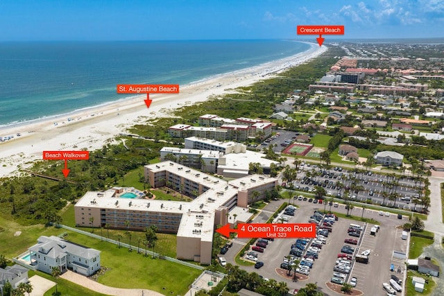 birds eye view of property with a water view and a view of the beach