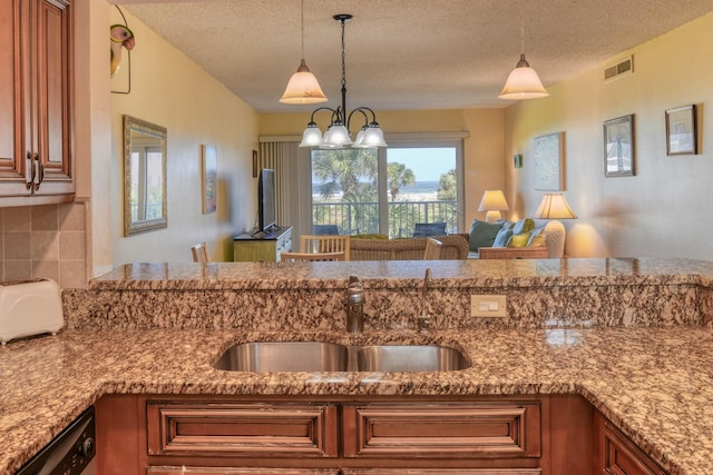 4 Ocean Trace Rd Unit 323, Saint Augustine Beach, FL 32080 - kitchen featuring dishwasher, a textured ceiling, brown cabinetry, hanging light fixtures, and light stone counters