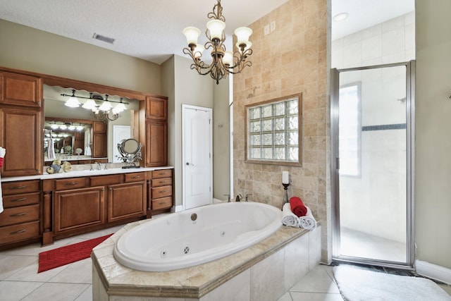 bathroom featuring tile patterned floors, vanity, a textured ceiling, an inviting chandelier, and plus walk in shower