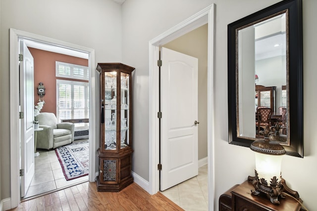 corridor with light hardwood / wood-style flooring