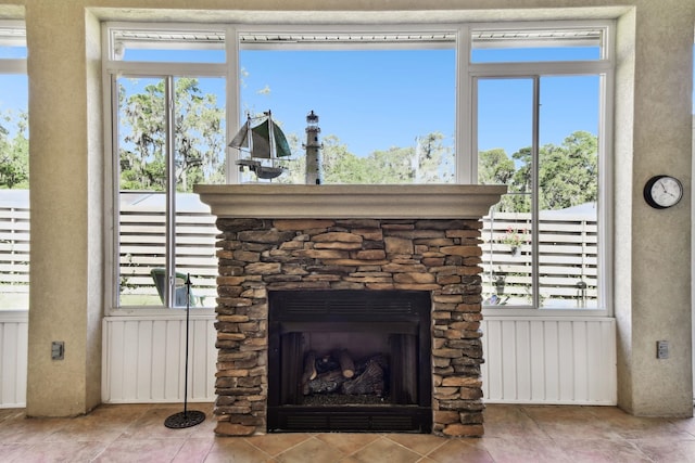 details with a stone fireplace and radiator