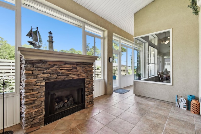 sunroom / solarium featuring wood ceiling and a fireplace