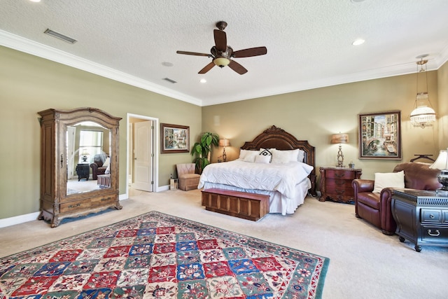 carpeted bedroom featuring a textured ceiling, ceiling fan, and ornamental molding