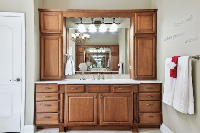 bathroom with vanity, an inviting chandelier, and tile patterned floors