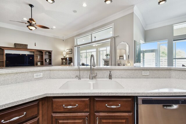 kitchen featuring dishwasher, ornamental molding, a healthy amount of sunlight, and sink