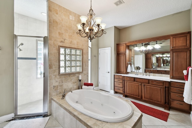 bathroom featuring plus walk in shower, an inviting chandelier, tile patterned flooring, vanity, and tile walls