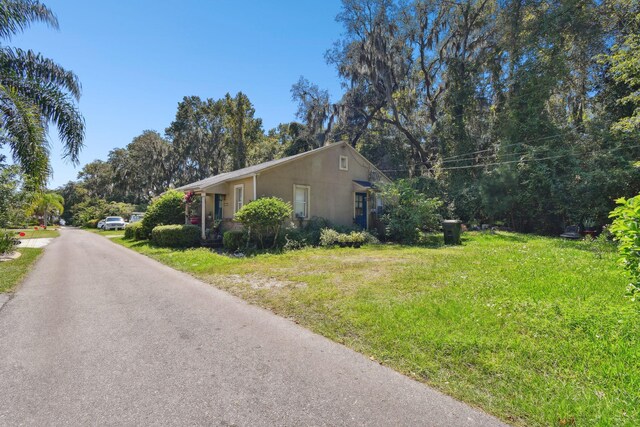 view of property exterior with a yard