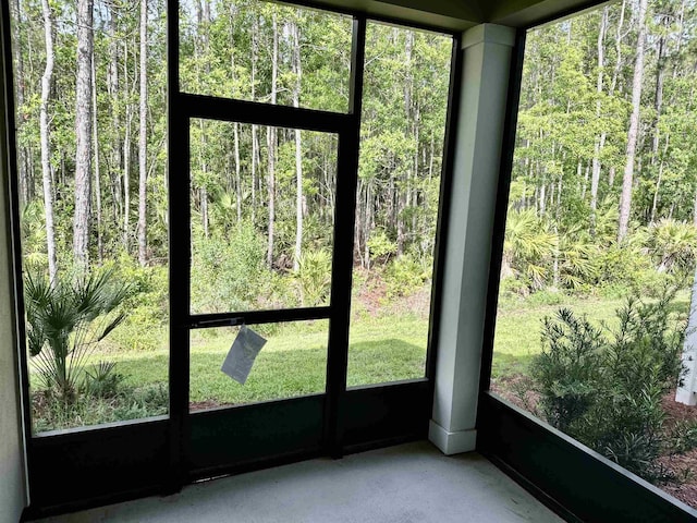 303 Redbud Rd, Palm Coast, FL 32137 - unfurnished sunroom with a forest view