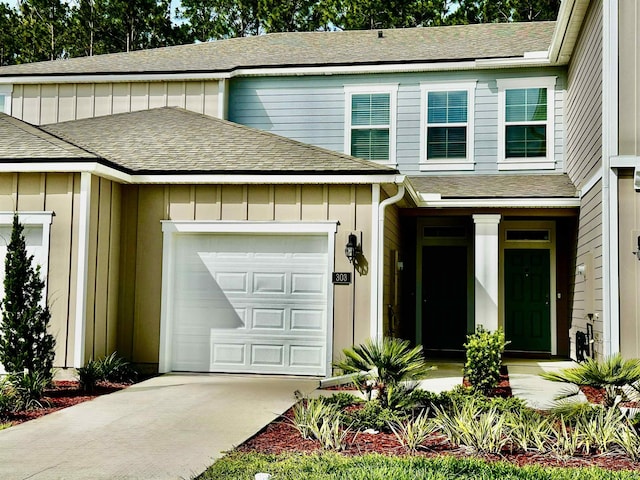303 Redbud Rd, Palm Coast, FL 32137 - view of front of property with a shingled roof, a garage, driveway, and board and batten siding