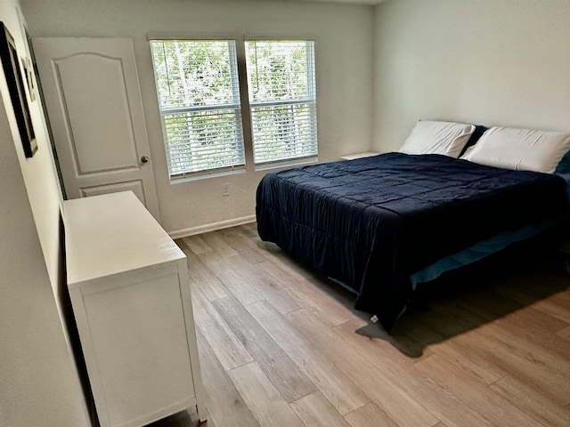 303 Redbud Rd, Palm Coast, FL 32137 - bedroom with light wood-style floors and baseboards