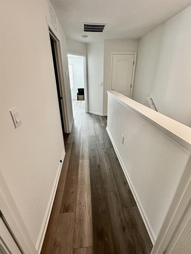 303 Redbud Rd, Palm Coast, FL 32137 - hallway with an upstairs landing, dark wood-style floors, and baseboards
