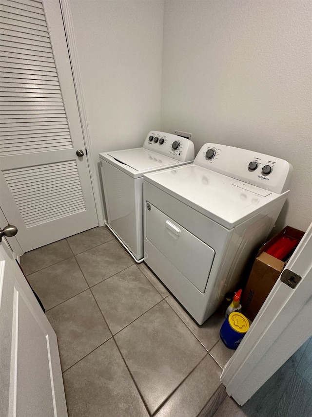 303 Redbud Rd, Palm Coast, FL 32137 - laundry room featuring washing machine and dryer and light tile patterned flooring