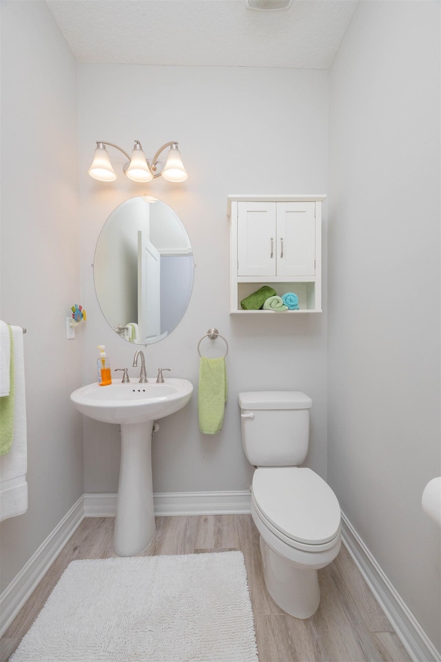 301 Graciela Cir, Saint Augustine, FL 32086 - half bath featuring wood finished floors, toilet, and baseboards