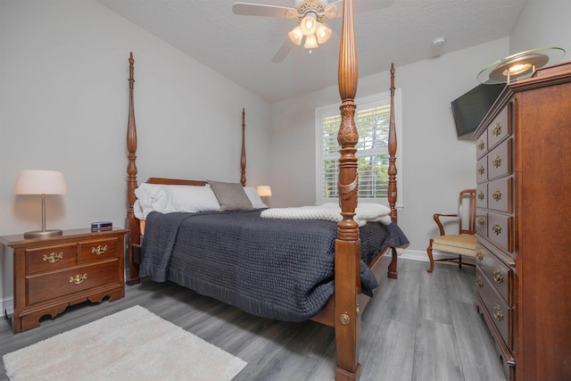 301 Graciela Cir, Saint Augustine, FL 32086 - bedroom featuring wood finished floors, a textured ceiling, baseboards, and ceiling fan
