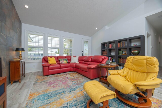 301 Graciela Cir, Saint Augustine, FL 32086 - living room featuring recessed lighting, vaulted ceiling, a textured ceiling, and light wood-style floors