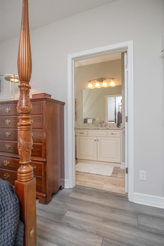 301 Graciela Cir, Saint Augustine, FL 32086 - interior space with baseboards, a sink, light wood-style floors, and connected bathroom